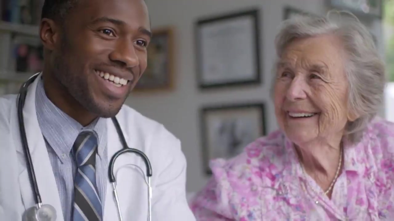 A physician visiting an elderly patient at home